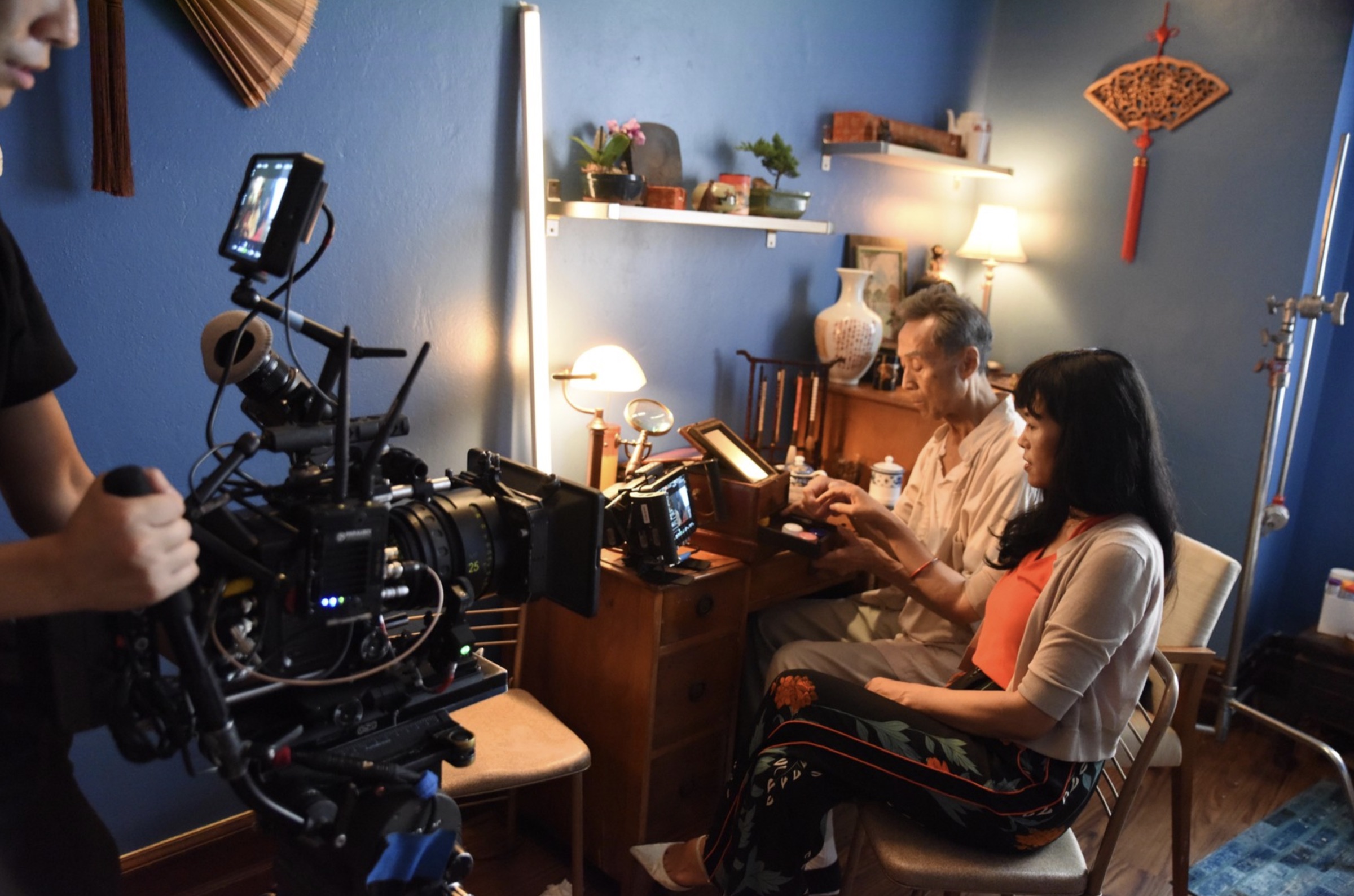 Grace Chang directing a scene on a film set with a cinema camera in the foreground