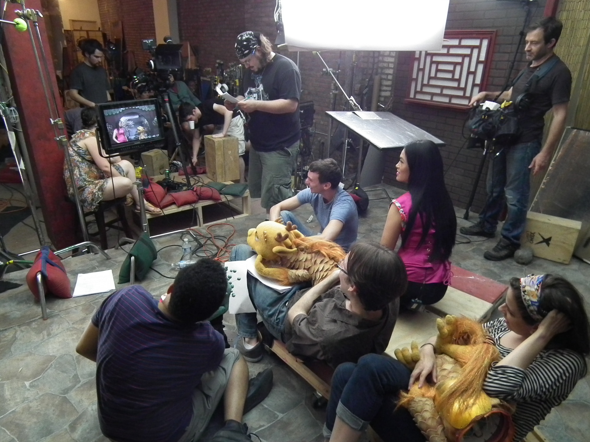 Film crew with dragon puppets on the Magical Garden set