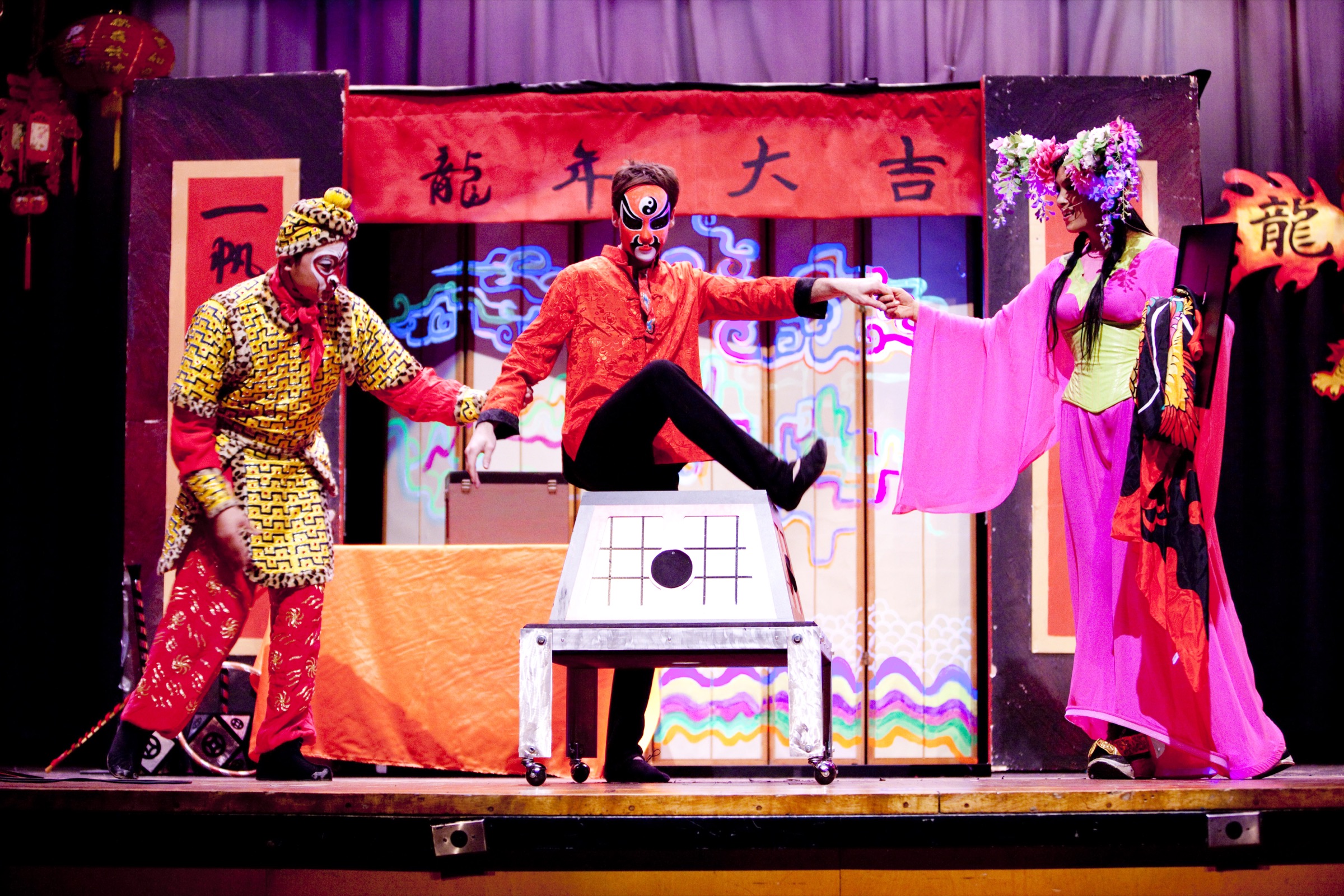 Wide stage view of a Lunar New Year production with red lanterns