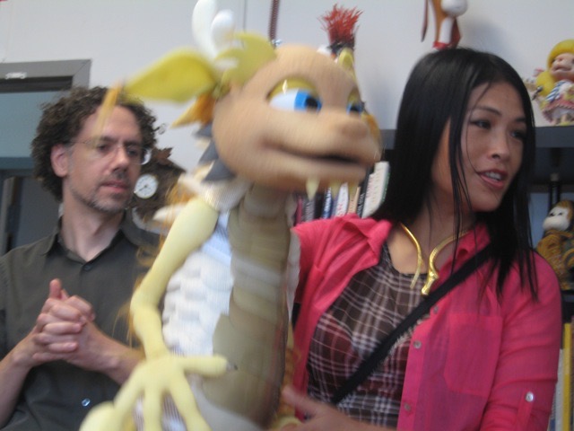 Grace Chang working on a puppet prototype at a workshop bench